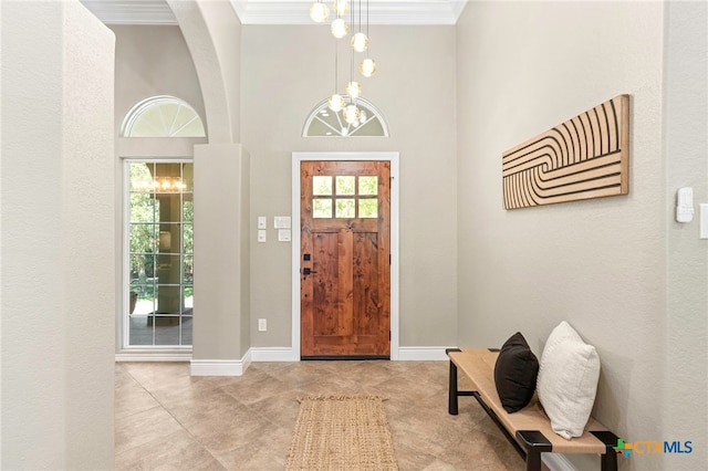 155 Woodrow Center Rd, Kingsbury, TX 78638 - entrance foyer featuring a chandelier, ornamental molding, arched walkways, and tile patterned floors