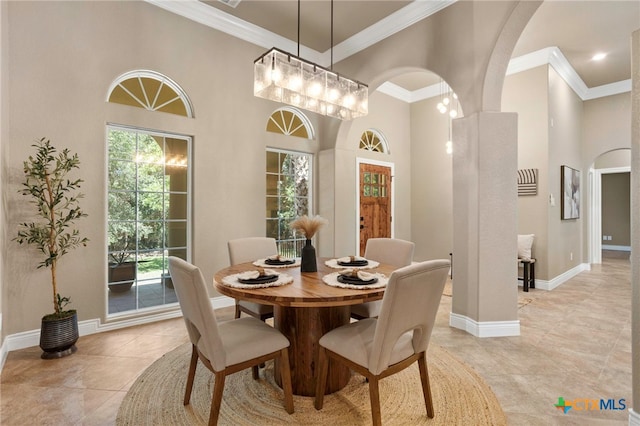 155 Woodrow Center Rd, Kingsbury, TX 78638 - dining space with arched walkways, ornamental molding, light tile patterned floors, and a high ceiling