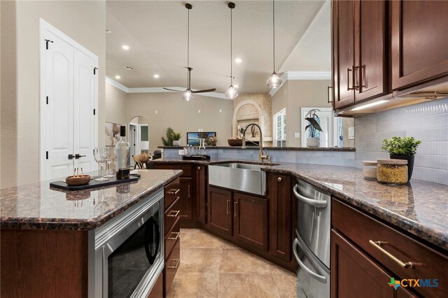 155 Woodrow Center Rd, Kingsbury, TX 78638 - kitchen with appliances with stainless steel finishes, ornamental molding, tasteful backsplash, ceiling fan, and dark stone counters