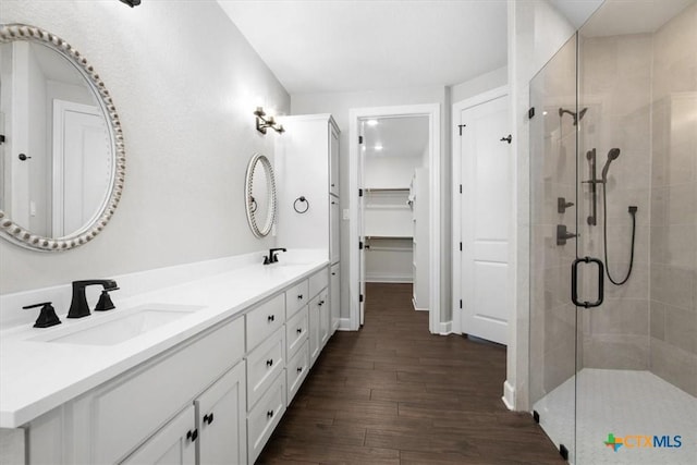 bathroom with an enclosed shower, vanity, and hardwood / wood-style floors