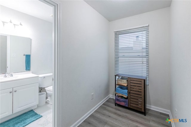 5304 Oster Dr, Killeen, TX 76542 - bathroom with toilet, vanity, baseboards, and wood finished floors