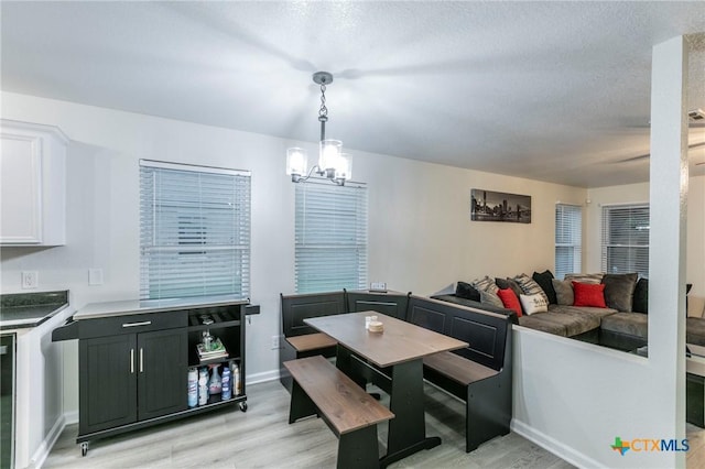 5304 Oster Dr, Killeen, TX 76542 - dining space featuring light wood-style flooring, a chandelier, and baseboards