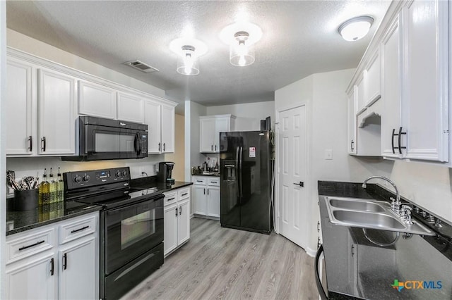 5304 Oster Dr, Killeen, TX 76542 - kitchen with black appliances, a textured ceiling, light wood-style flooring, white cabinetry, and a sink