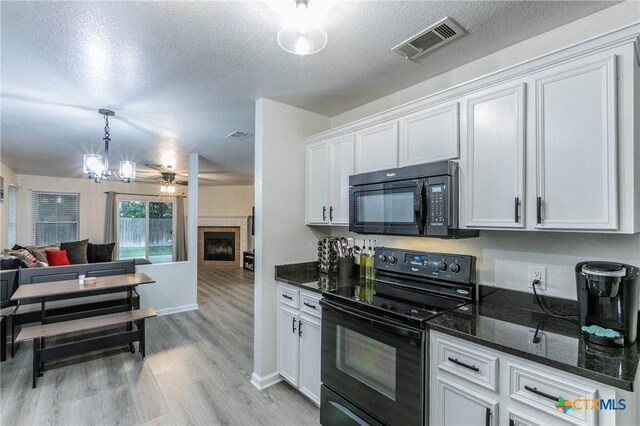 5304 Oster Dr, Killeen, TX 76542 - kitchen featuring black appliances, open floor plan, light wood-type flooring, white cabinets, and a fireplace