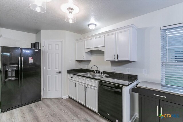 5304 Oster Dr, Killeen, TX 76542 - kitchen with black appliances, a sink, light wood-style floors, dark countertops, and white cabinets