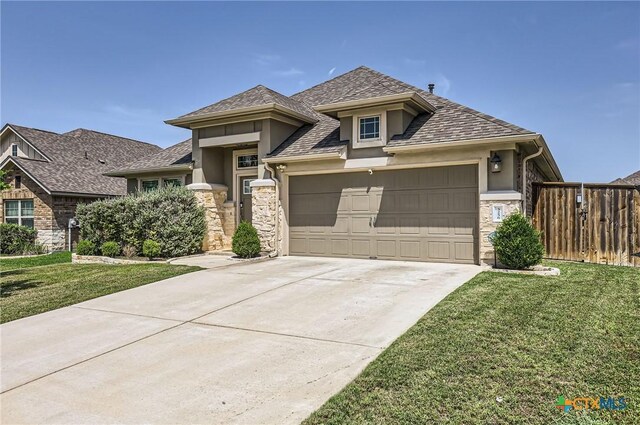 3256 Pablo Cir, Round Rock, TX 78665 - view of front of home with stucco siding, stone siding, an attached garage, driveway, and roof with shingles