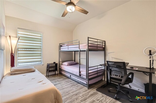3256 Pablo Cir, Round Rock, TX 78665 - bedroom with wood finished floors, an office area, lofted ceiling, and a ceiling fan