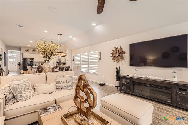 3256 Pablo Cir, Round Rock, TX 78665 - living room with light wood-style floors, baseboards, recessed lighting, and vaulted ceiling
