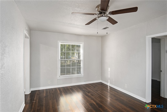 spare room featuring a textured ceiling, dark hardwood / wood-style flooring, and ceiling fan