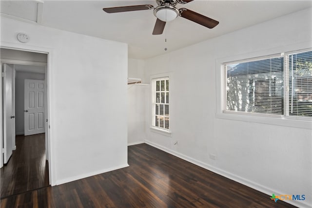 spare room with ceiling fan and dark wood-type flooring