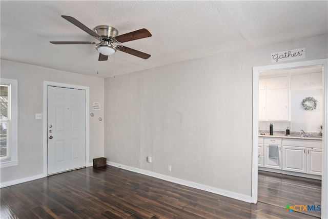 foyer featuring ceiling fan, dark hardwood / wood-style flooring, a textured ceiling, and sink