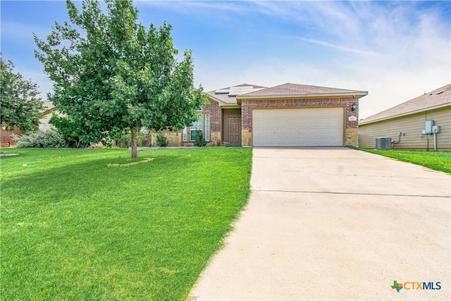 1217 Roanoke Dr, Temple, TX 76504 - view of front of property with brick siding, a garage, a front lawn, driveway, and solar panels