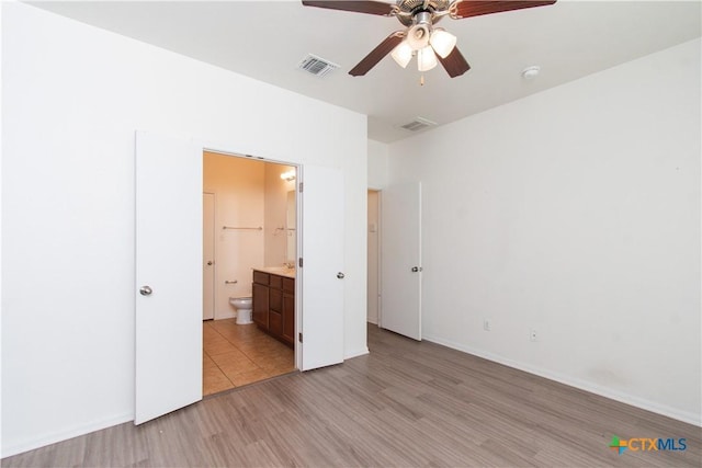 1217 Roanoke Dr, Temple, TX 76504 - unfurnished bedroom featuring light wood-style flooring, connected bathroom, and a ceiling fan