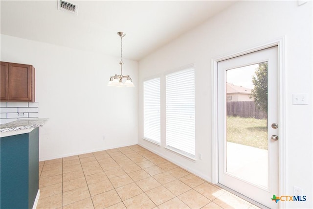 1217 Roanoke Dr, Temple, TX 76504 - unfurnished dining area with a chandelier, healthy amount of natural light, and light tile patterned floors
