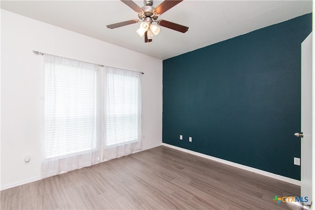 1217 Roanoke Dr, Temple, TX 76504 - spare room featuring wood finished floors and ceiling fan