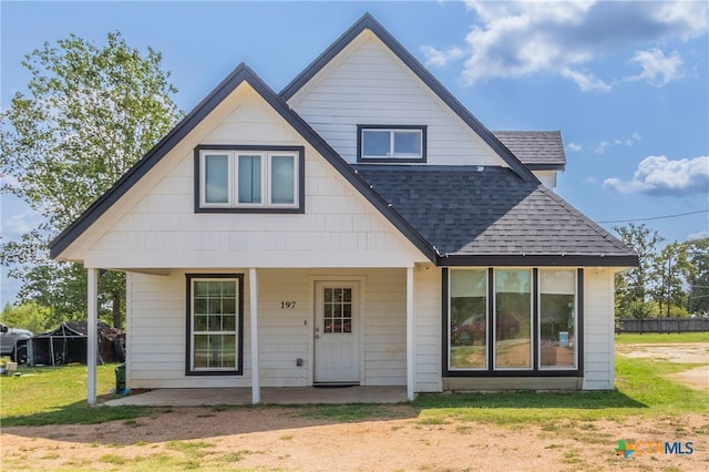 rear view of house with a patio area and a lawn