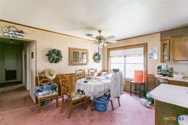 dining area featuring light colored carpet and ceiling fan