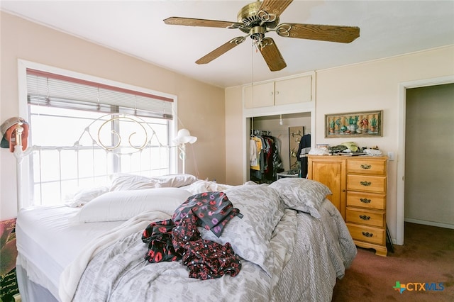 carpeted bedroom featuring ceiling fan, multiple windows, and a closet