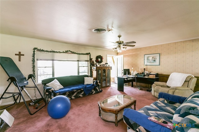 living room featuring ornamental molding, carpet, and ceiling fan