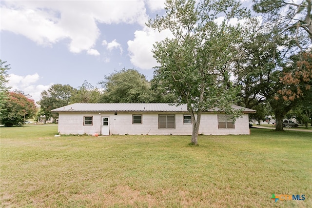 rear view of property with a yard