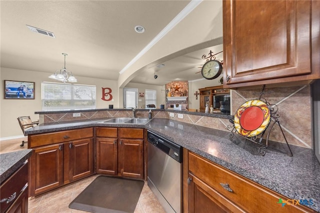 8717 Surrey Ct, Temple, TX 76502 - kitchen with dishwasher, arched walkways, decorative backsplash, dark countertops, and ornamental molding
