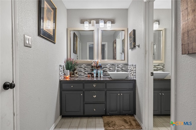 bathroom featuring vanity and decorative backsplash