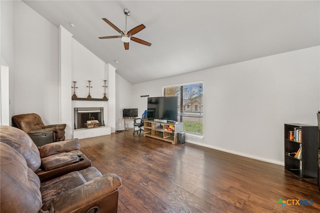 living room featuring ceiling fan, a fireplace, dark hardwood / wood-style floors, and high vaulted ceiling