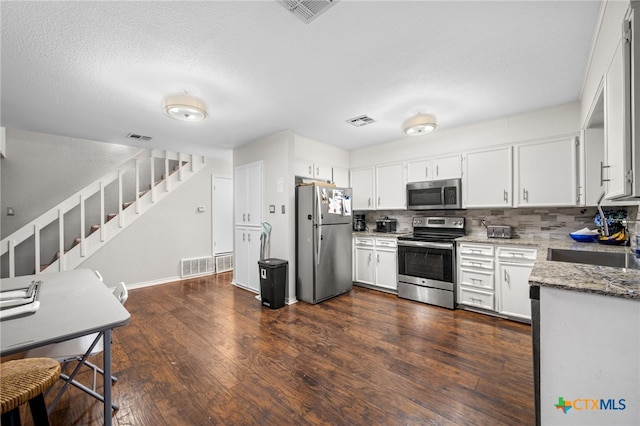 kitchen with tasteful backsplash, sink, white cabinets, stainless steel appliances, and light stone countertops