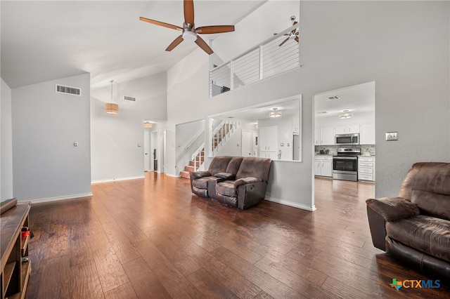 living room featuring hardwood / wood-style flooring, high vaulted ceiling, and ceiling fan