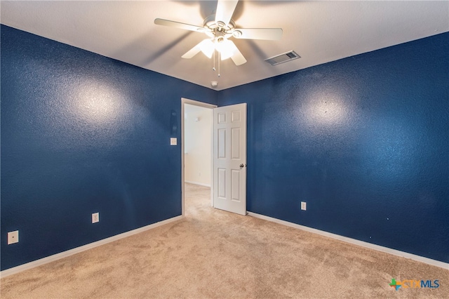 unfurnished room featuring ceiling fan and light carpet