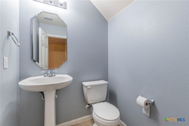 bathroom with tile patterned floors, toilet, and sink