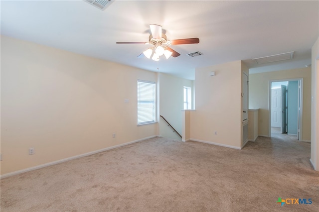 unfurnished room with ceiling fan and light colored carpet