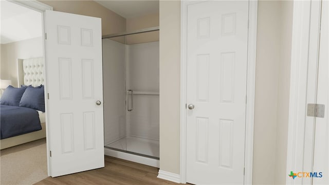 bathroom featuring walk in shower and hardwood / wood-style flooring