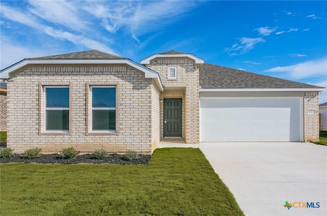 view of front of property with a garage and a front lawn