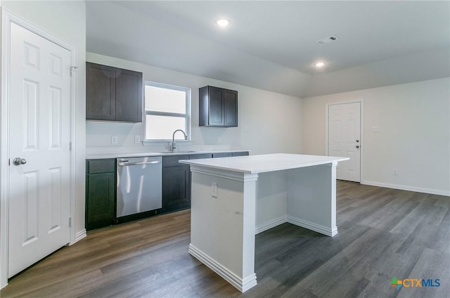 kitchen with stainless steel dishwasher, dark hardwood / wood-style flooring, sink, and a kitchen island