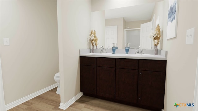 bathroom featuring wood-type flooring, vanity, and toilet