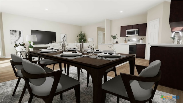 dining room featuring light wood-type flooring and sink