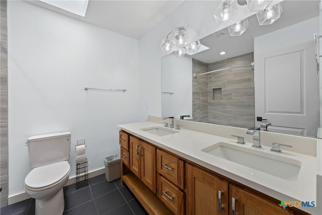 1600 N Beal St, Belton, TX 76513 - bathroom with double vanity, tiled shower, a skylight, and tile patterned floors
