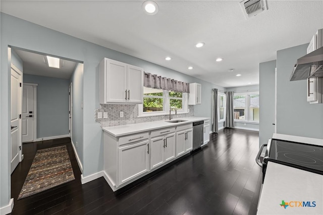 1600 N Beal St, Belton, TX 76513 - kitchen with stainless steel appliances, light countertops, dark wood-type flooring, white cabinets, and healthy amount of natural light