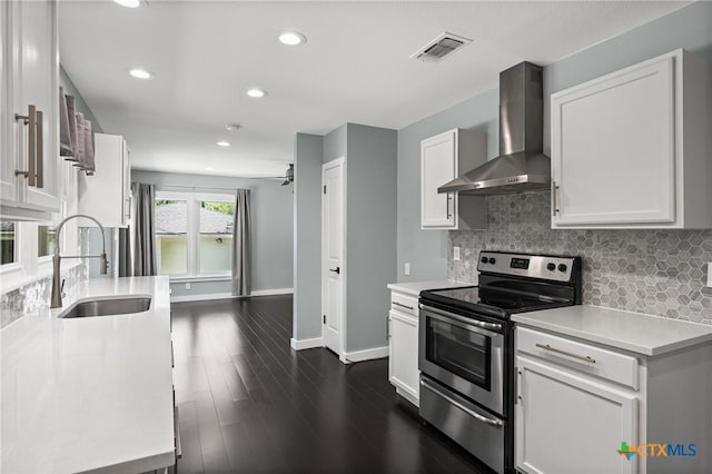 1600 N Beal St, Belton, TX 76513 - kitchen with wall chimney range hood, stainless steel range with electric stovetop, tasteful backsplash, light countertops, and white cabinets