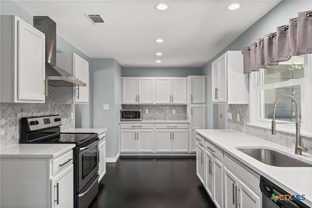 1600 N Beal St, Belton, TX 76513 - kitchen featuring stainless steel appliances, wall chimney range hood, backsplash, light countertops, and white cabinetry