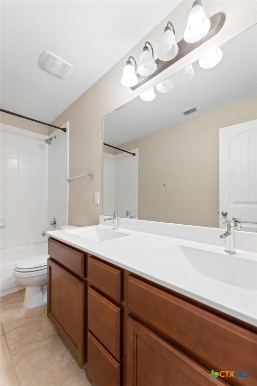 3907 Gentle Mdw, New Braunfels, TX 78130 - full bath with double vanity, toilet, shower / bathtub combination, and tile patterned flooring