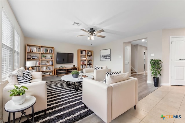 3907 Gentle Mdw, New Braunfels, TX 78130 - living area featuring a ceiling fan, stairs, baseboards, and light tile patterned floors