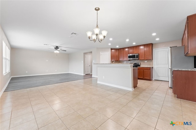 3907 Gentle Mdw, New Braunfels, TX 78130 - kitchen with appliances with stainless steel finishes, a chandelier, recessed lighting, ceiling fan, and brown cabinetry