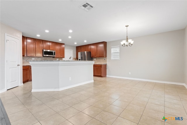 3907 Gentle Mdw, New Braunfels, TX 78130 - kitchen featuring appliances with stainless steel finishes, a chandelier, tasteful backsplash, light tile patterned floors, and recessed lighting