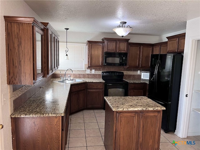 kitchen with pendant lighting, a center island, black appliances, sink, and light tile patterned floors