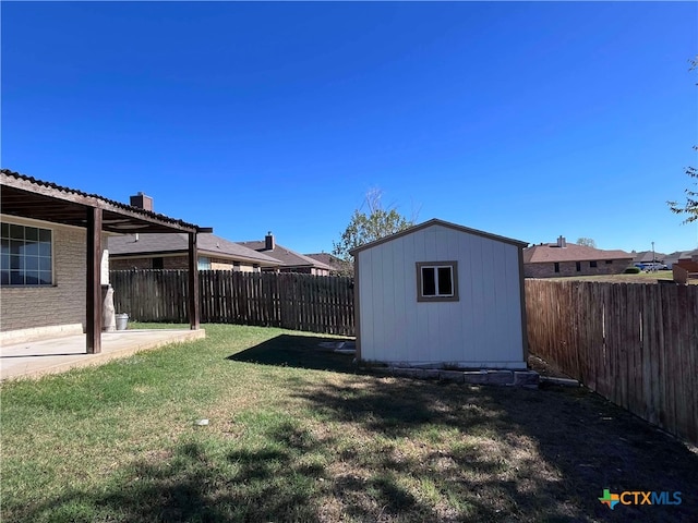 view of yard featuring a storage unit and a patio area