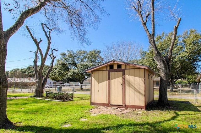 view of outbuilding with a yard