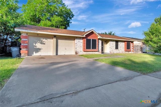 1808 Mission Dr, Victoria, TX 77901 - ranch-style home with an attached garage, a front yard, concrete driveway, and brick siding