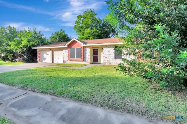 1808 Mission Dr, Victoria, TX 77901 - single story home with a garage, a front yard, concrete driveway, and brick siding